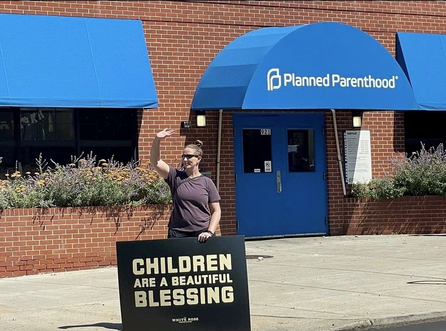 Rebecca Winegar holding a sign outside Planned Parenthood of the Rocky Mountains, September 2024